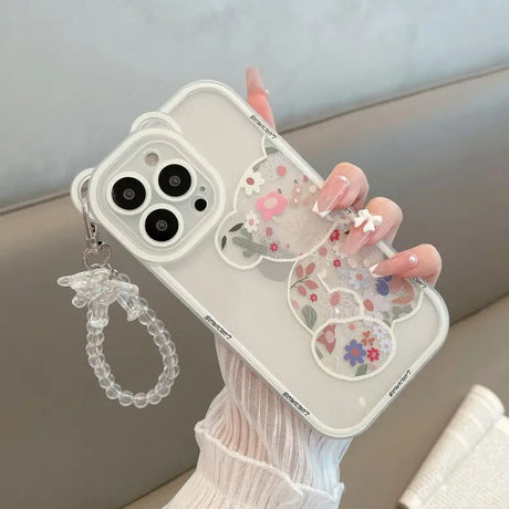 a woman holding a phone case with a flower design