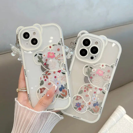 a woman holding a phone case with flowers on it