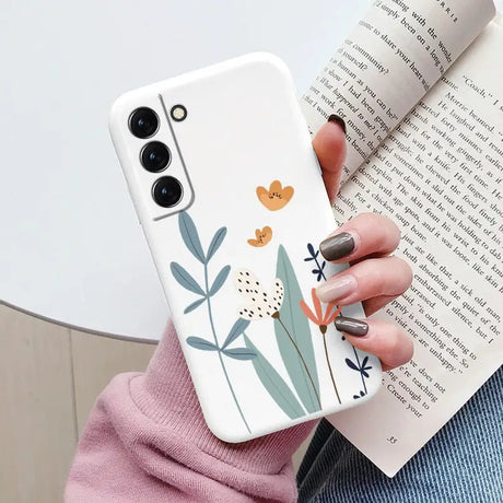 a woman holding a phone case with a flower design