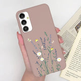 a woman holding a phone case with flowers on it