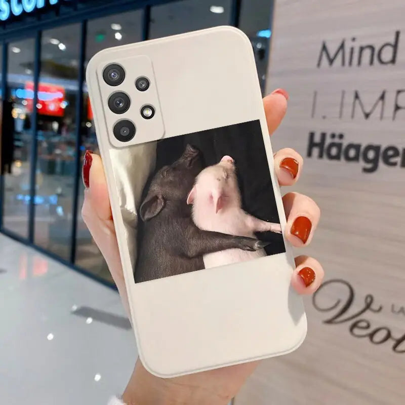 a woman holding a phone with a photo of a rat