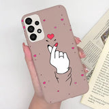 a woman holding a phone case with a heart on it