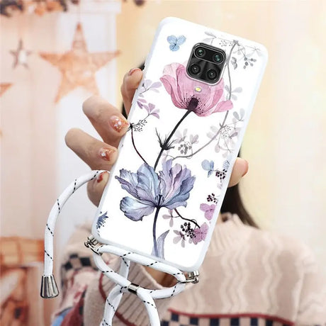 a woman holding a phone case with flowers on it