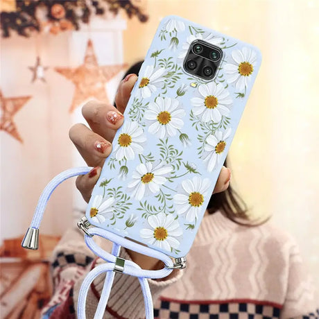 a woman holding a phone case with flowers on it