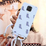 a woman holding a phone case with a pattern of dinosaurs on it