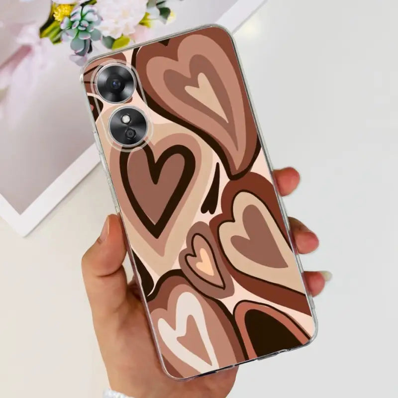 a woman holding a phone case with a heart pattern