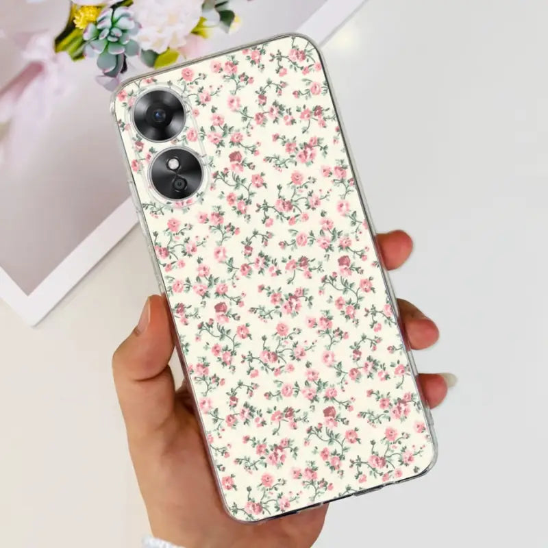 a woman holding a phone case with a floral pattern