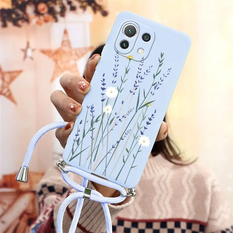 a woman holding a phone case with a flower design