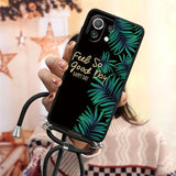 a woman holding a phone case with a palm leaf design