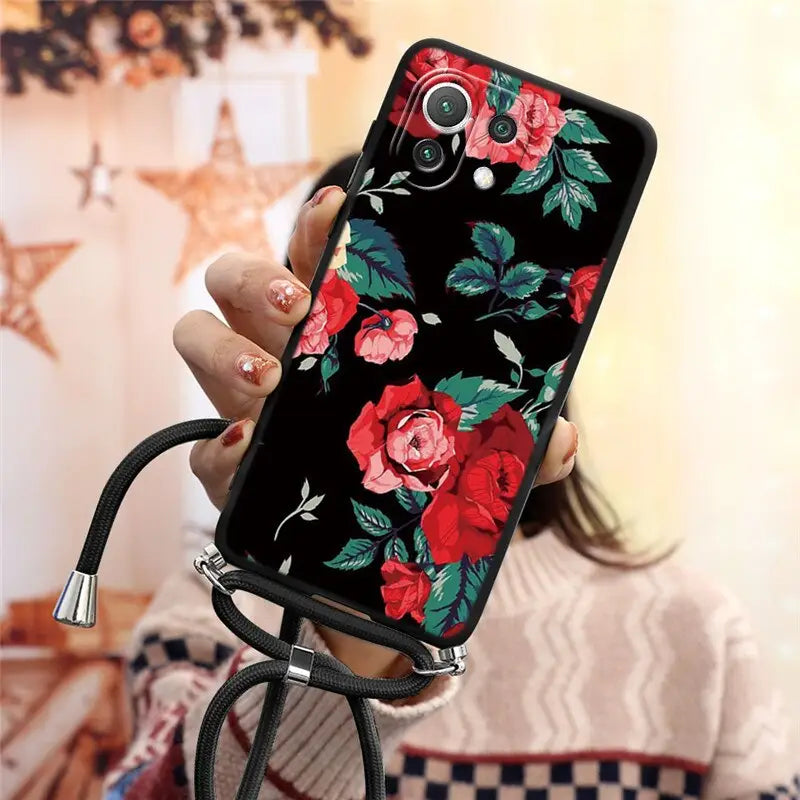 a woman holding a phone case with flowers on it