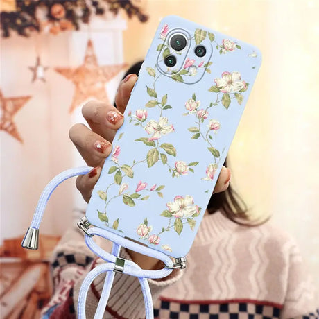 a woman holding a phone case with flowers on it