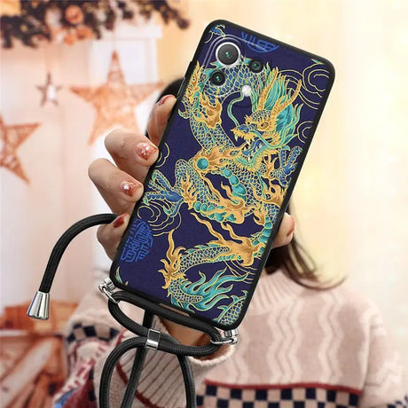 a woman holding a phone case with a dragon design