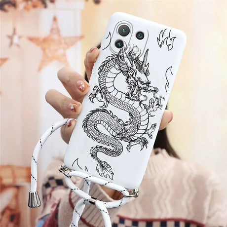 a woman holding a phone case with a dragon on it