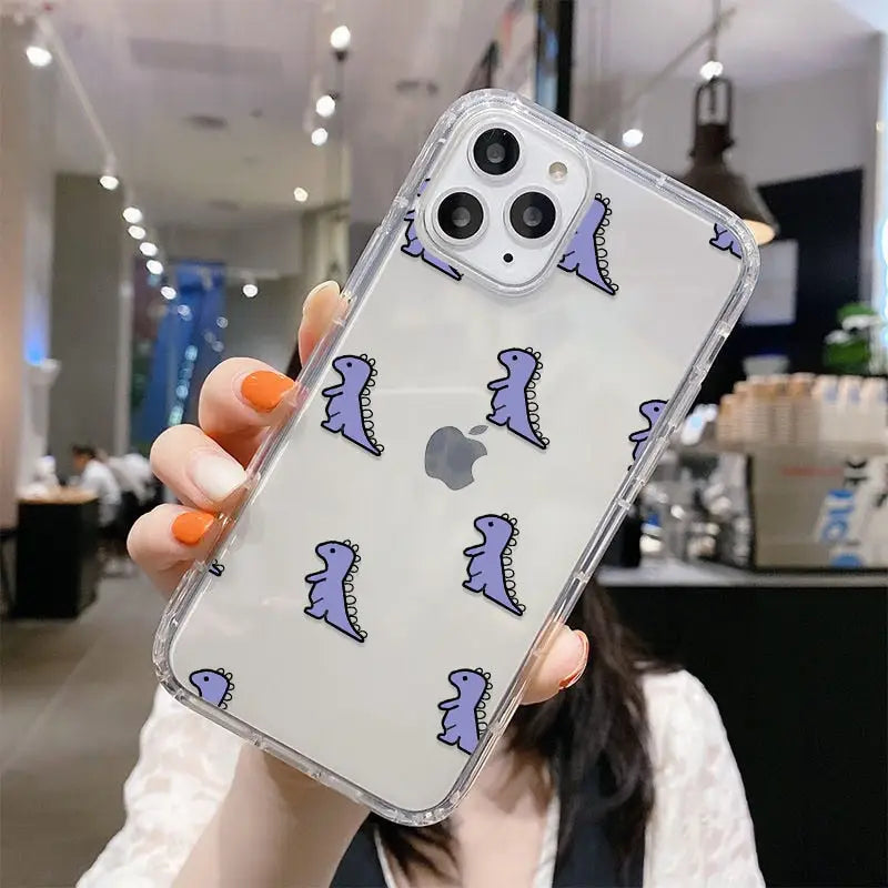 a woman holding up a phone case with a purple and blue pattern