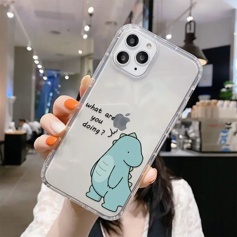 a woman holding up a phone case with a cartoon character on it