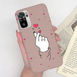 a woman holding a phone case with a heart on it