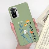 a woman holding a phone case with flowers on it