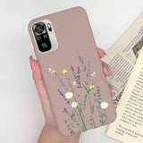 a woman holding a phone case with flowers on it