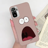 a person holding a phone case with a cartoon face