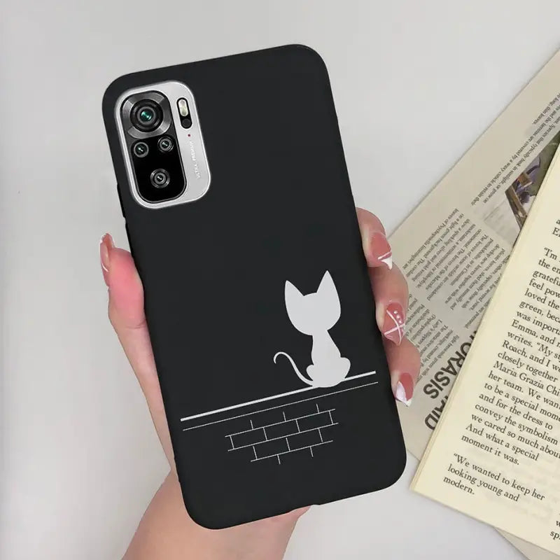 a woman holding a phone case with a cat on it