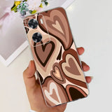 a woman holding a phone case with a heart pattern