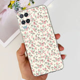 a woman holding a phone case with a floral pattern