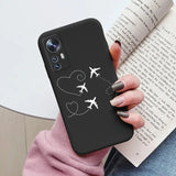 a woman holding a phone case with a plane and heart