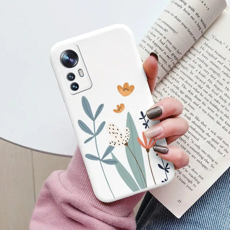 a woman holding a phone case with a flower design