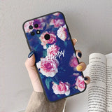 a woman holding a phone case with flowers on it