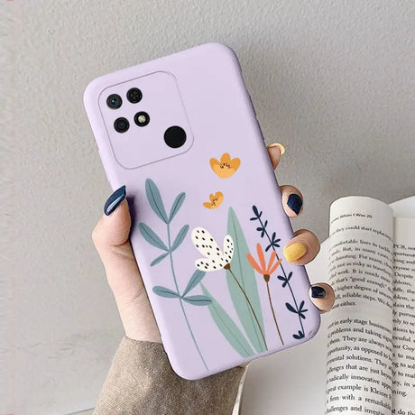 a woman holding a phone case with flowers on it