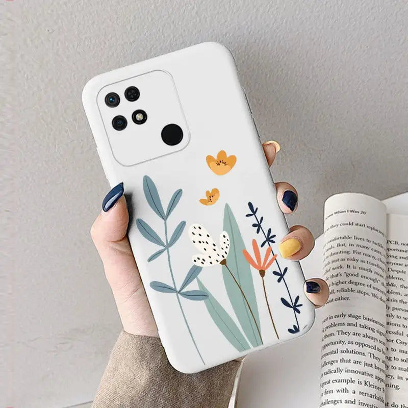 a woman holding a phone case with a flower design