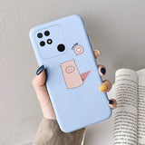 a hand holding a phone case with a cartoon face on it