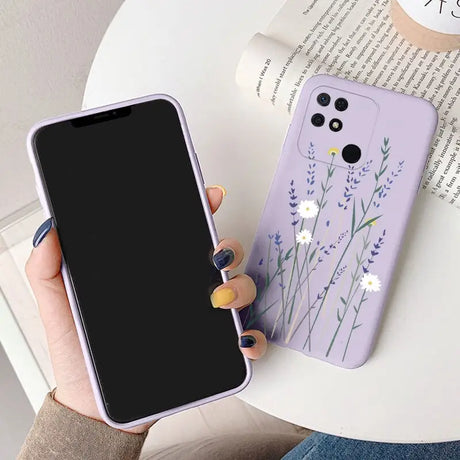 a woman holding a phone case with a flower design