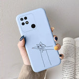 a woman holding a phone case with a cat drawing on it