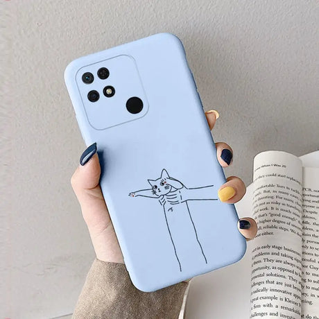 a woman holding a phone case with a cat drawing on it