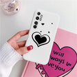 a woman holding a phone case with a heart on it