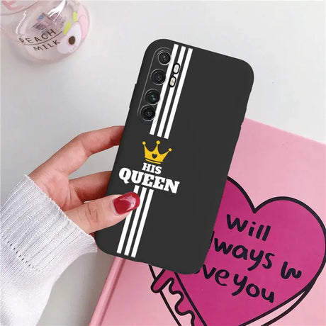 a woman holding a phone case with the queen on it