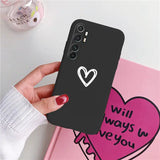 a woman holding a phone case with a heart