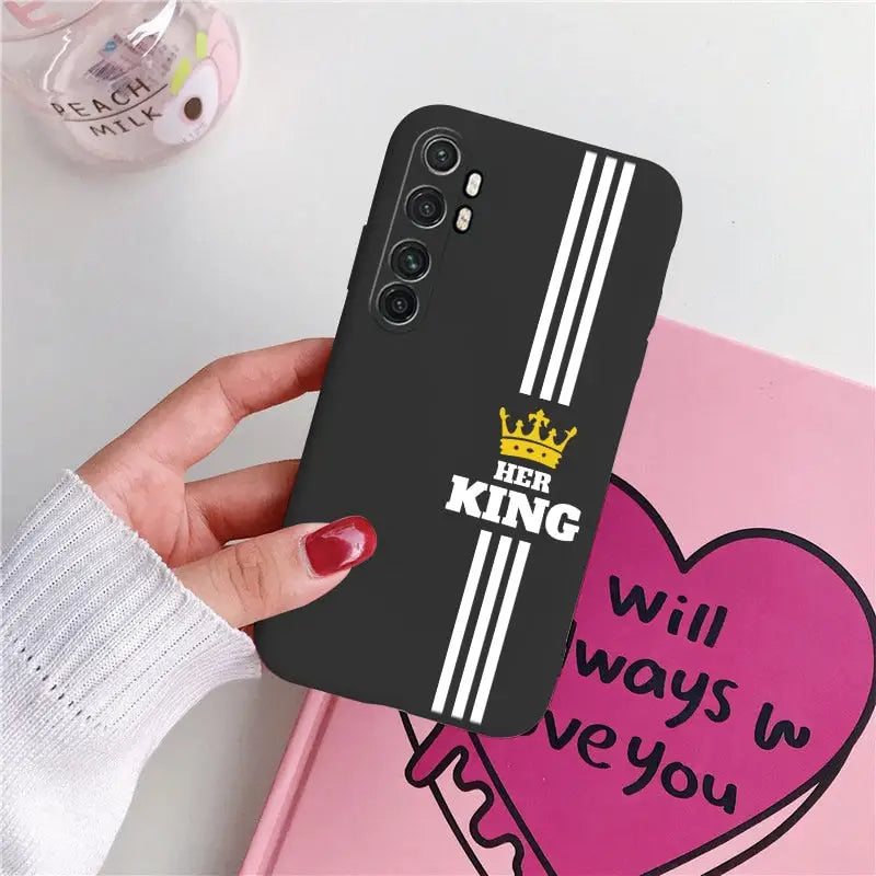 a woman holding a phone case with the words king and queen