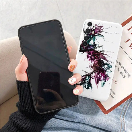 a woman holding a phone case with a flower design