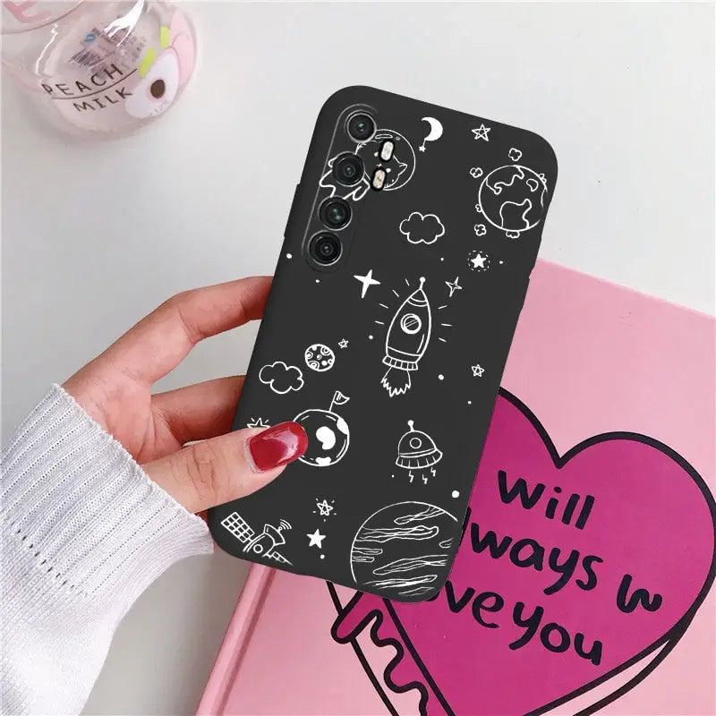 a hand holding a phone case with a heart and stars