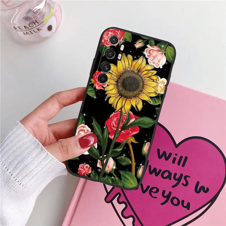 a woman holding a phone case with a sunflower on it