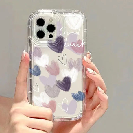 a woman holding a phone case with hearts on it