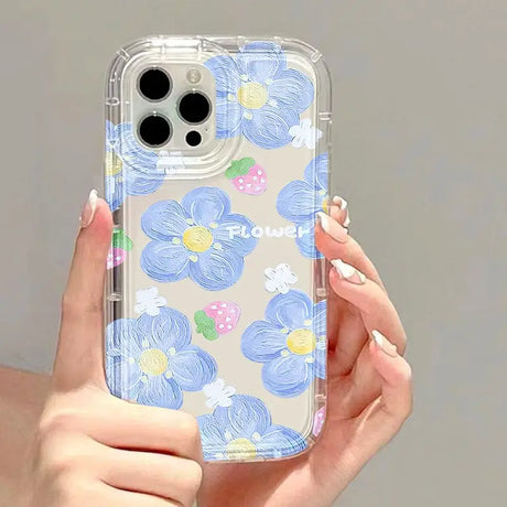 a woman holding a phone case with flowers on it