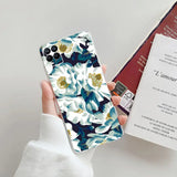 a woman holding a phone case with a floral pattern