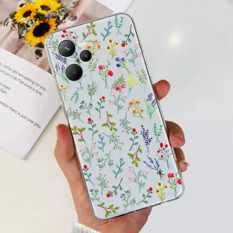 a woman holding a phone case with flowers on it