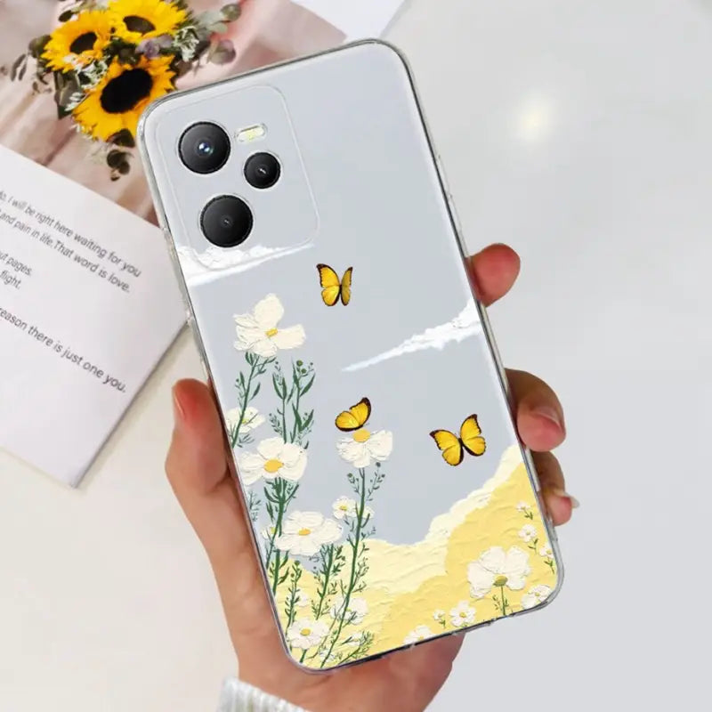 a woman holding a phone case with a yellow butterfly on it