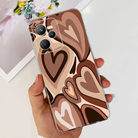 a woman holding a phone case with a heart pattern