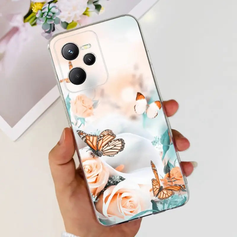 a woman holding a phone case with a butterfly and flowers on it