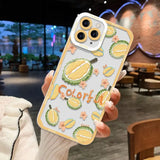a woman holding up a phone case with a lemon pattern